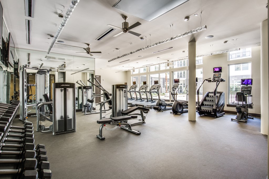 a gym with cardio machines and other exercise equipment