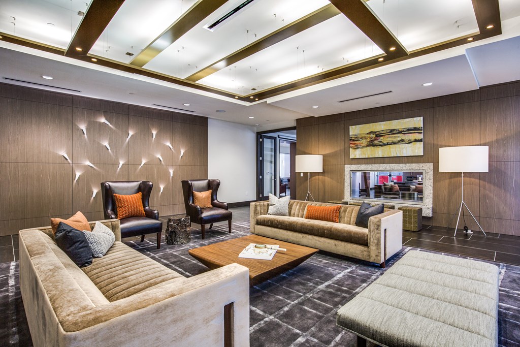 a living room with couches and chairs and a fireplace