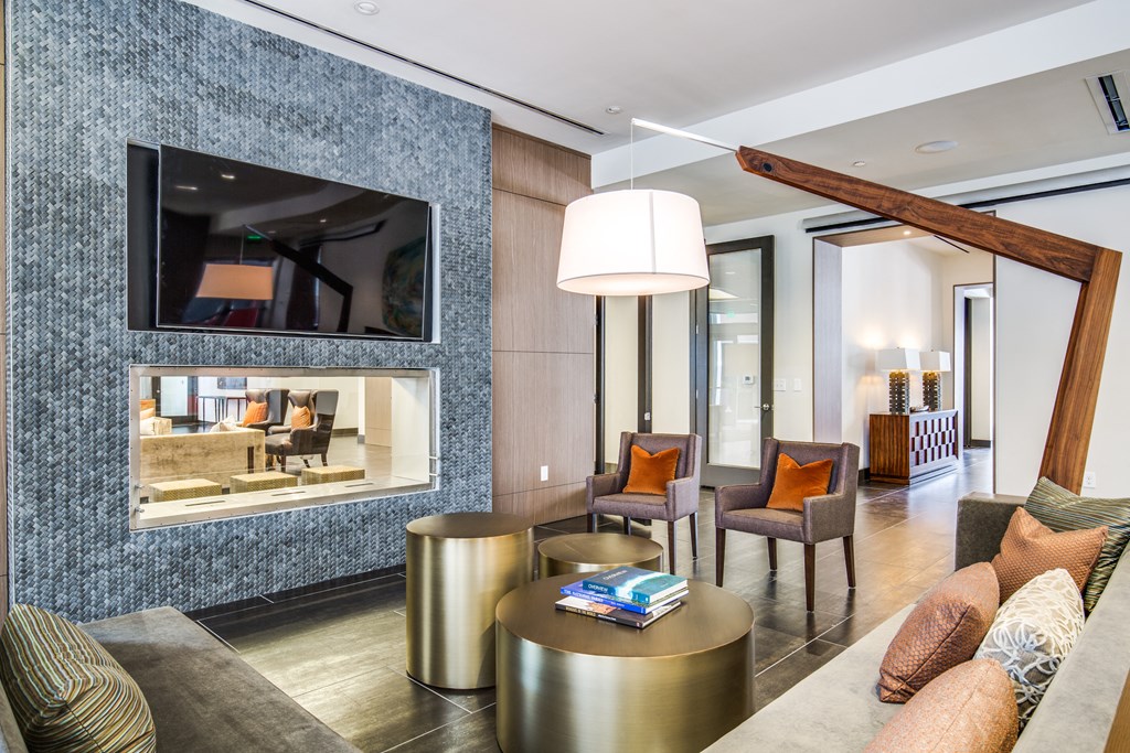 a living room with a couch and chairs and a television