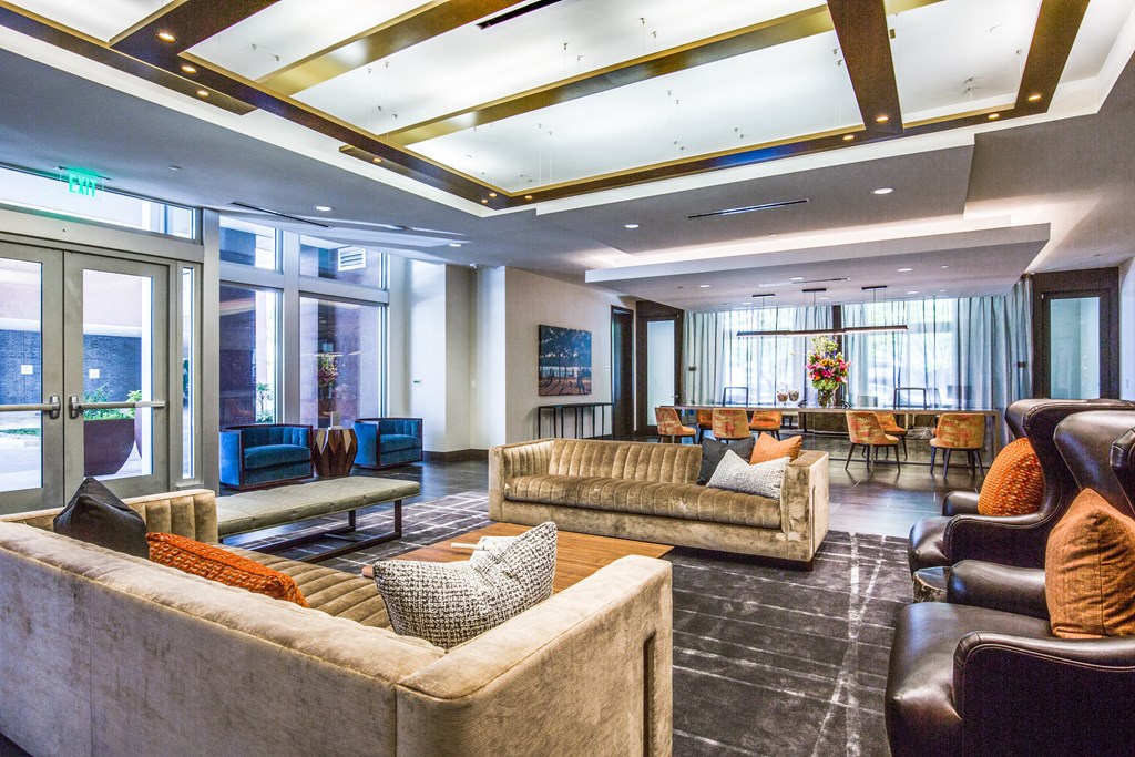 a large living room with couches and chairs and a table