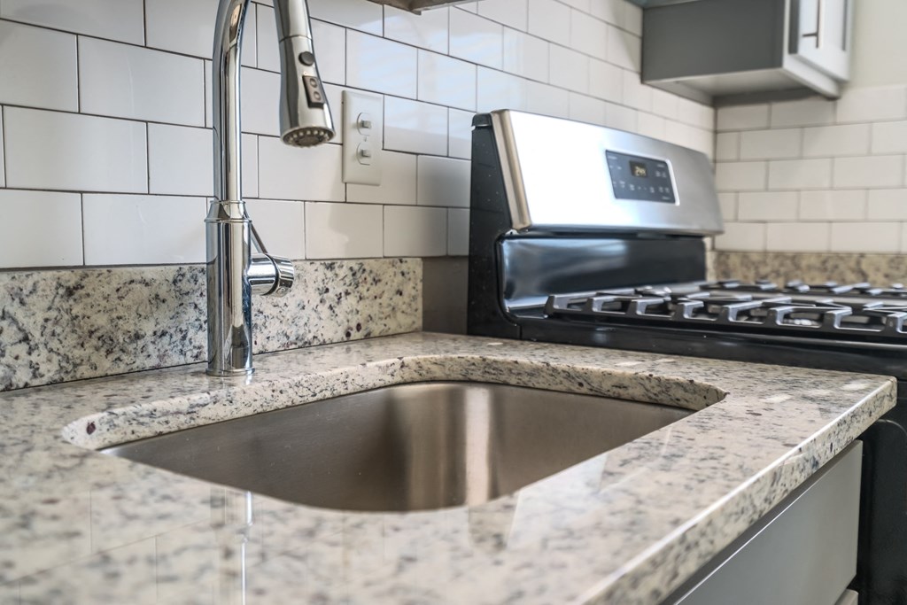 a kitchen with a sink and a stove