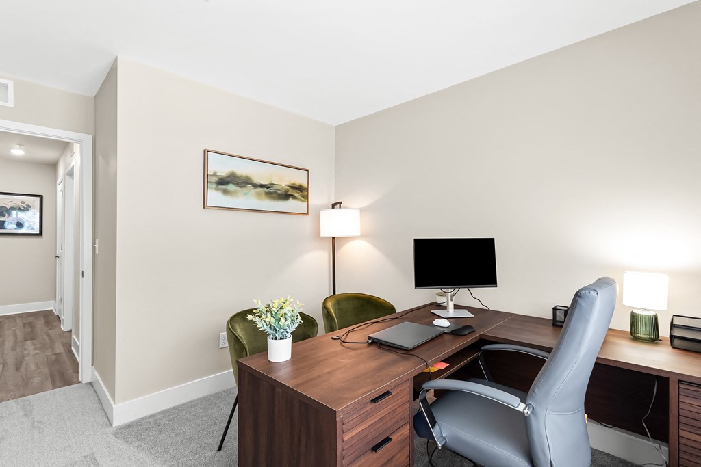 a room with a desk and a chair and a computer