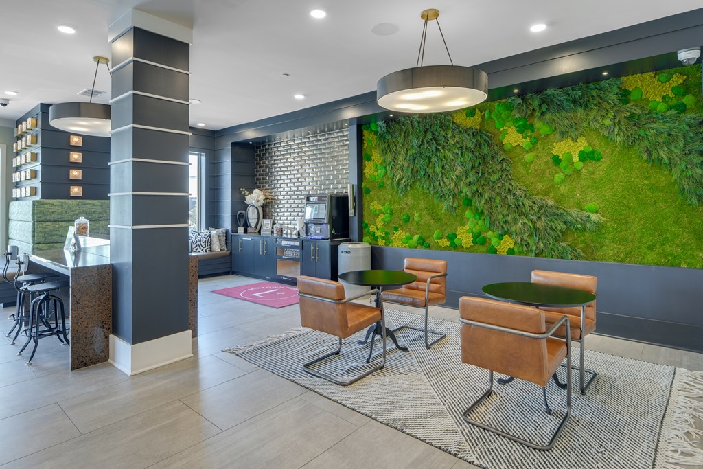 A modern living room with a green wall mural and a variety of seating options.