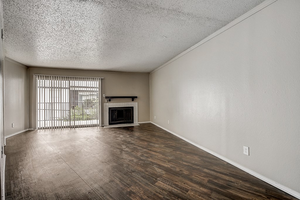a living room with a fireplace and a large window
