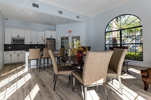 A dining room with a table and chairs.