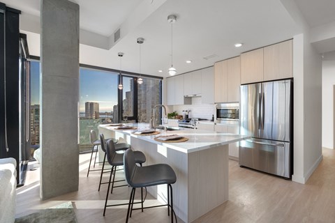 A modern kitchen with a dining table and chairs.
