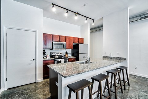kitchen with an island with granite countertops