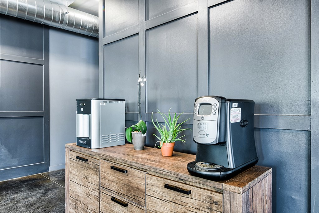 a cabinet with a coffee maker and a printer on top of a wooden desk