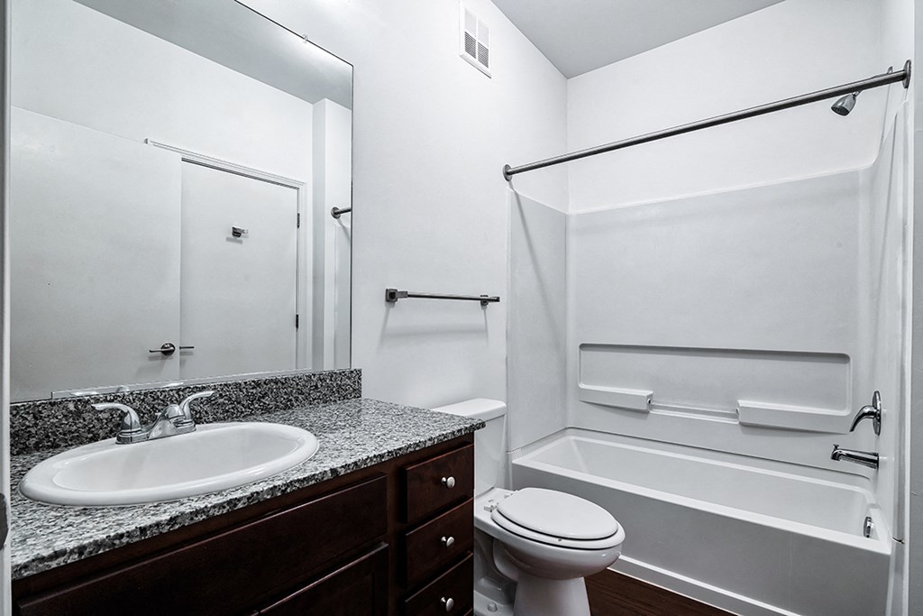a bathroom with a shower sink and toilet