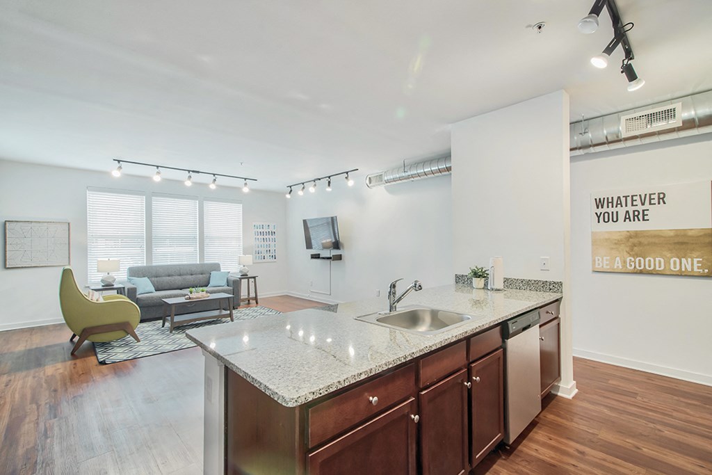 a kitchen with an island and a living room with a couch