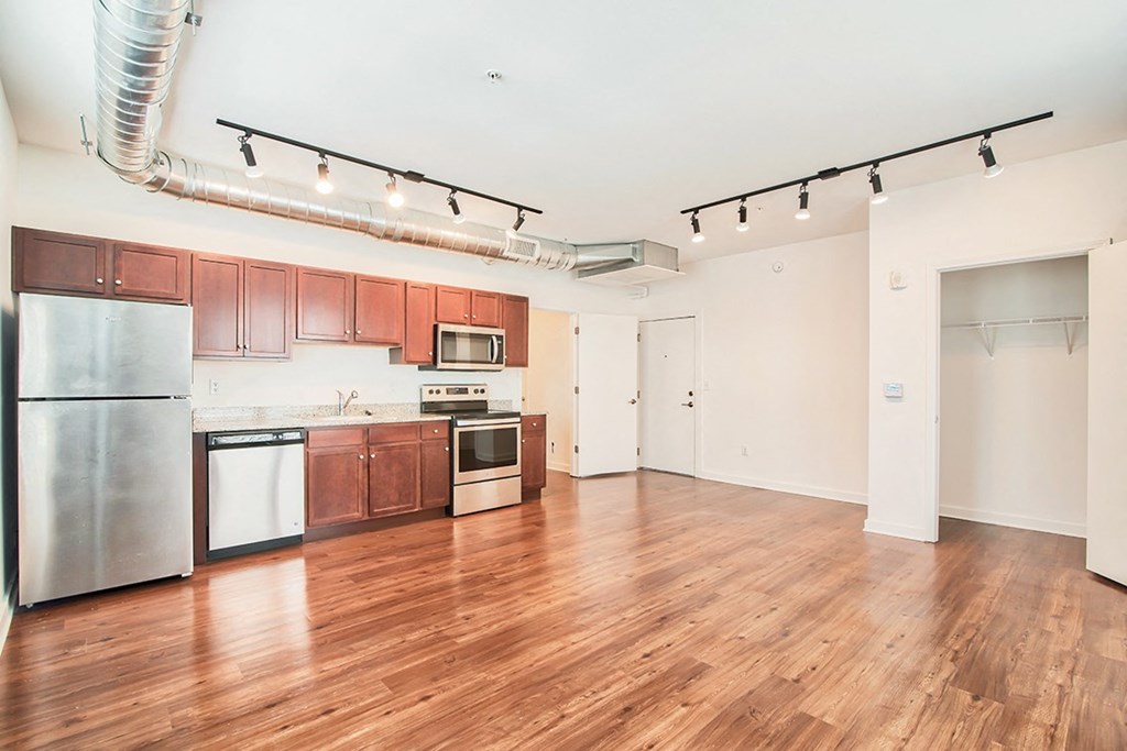 kitchen and living room with wood floors and white walls
