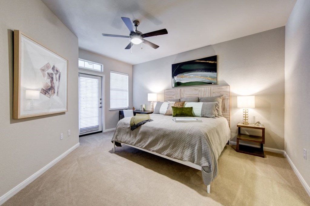a bedroom with a ceiling fan and a bed