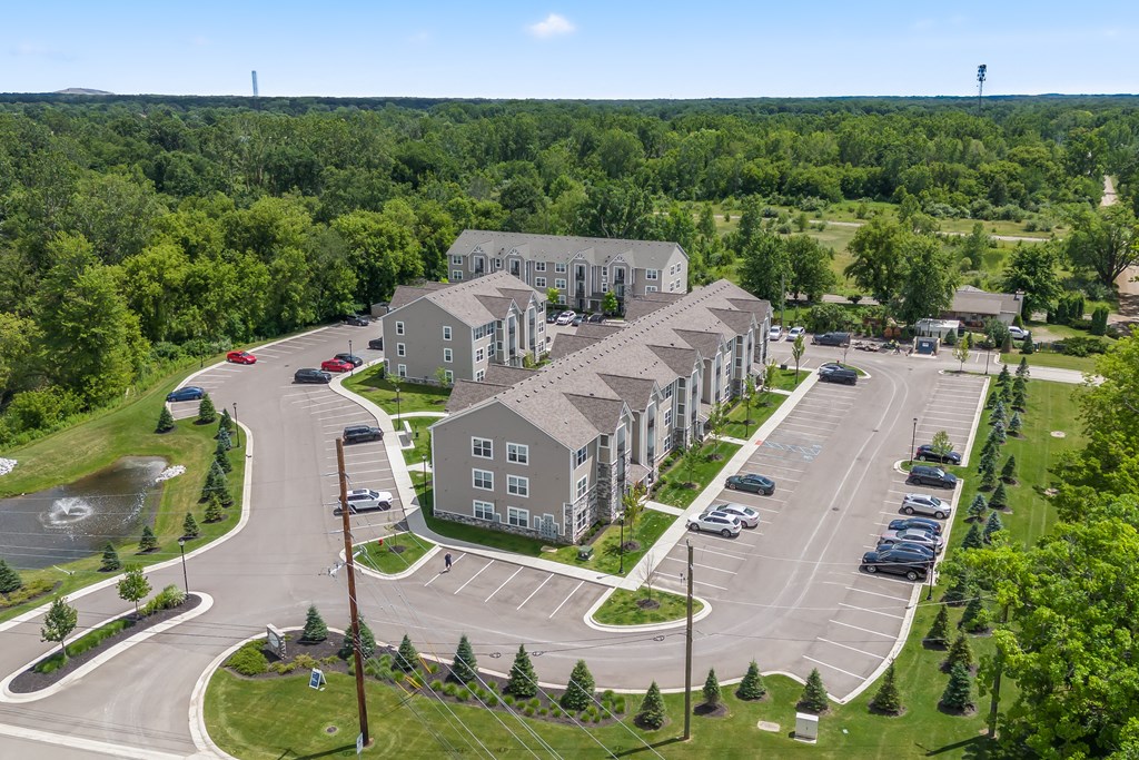 A large building complex with a parking lot in front.