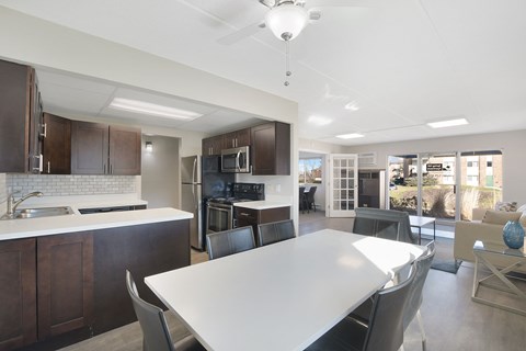 a kitchen and dining room with a white table and chairs