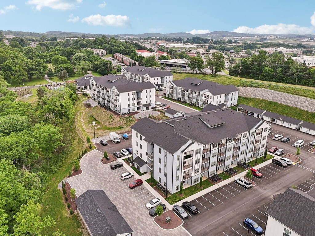 A large white building with a parking lot in front of it.