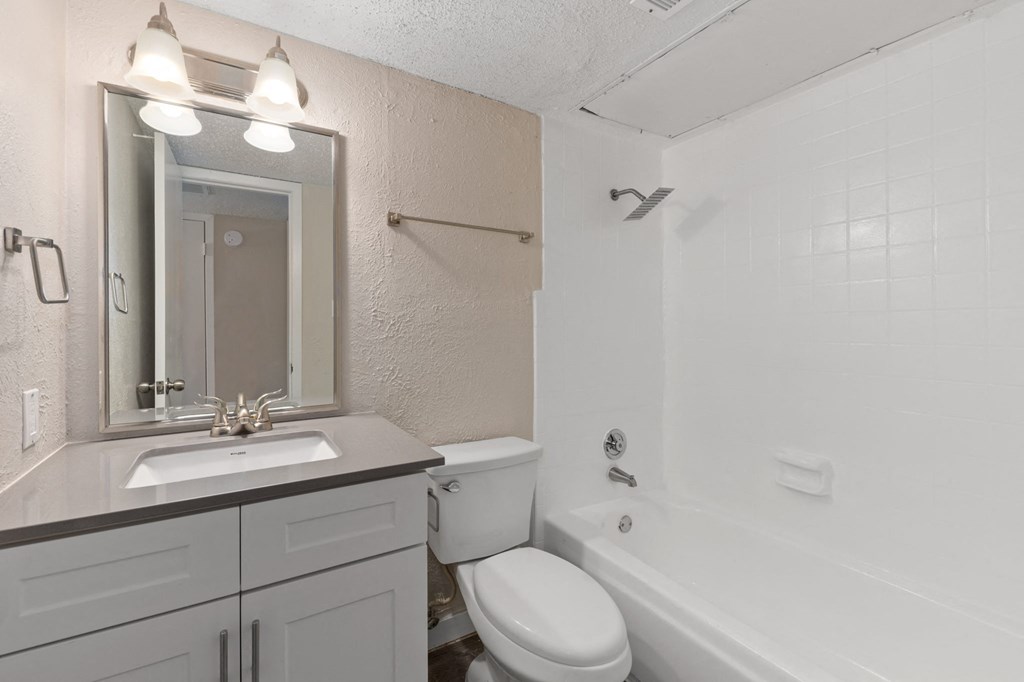 a bathroom with a sink toilet and bathtub