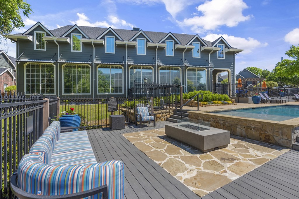 a backyard with a pool and a blue house