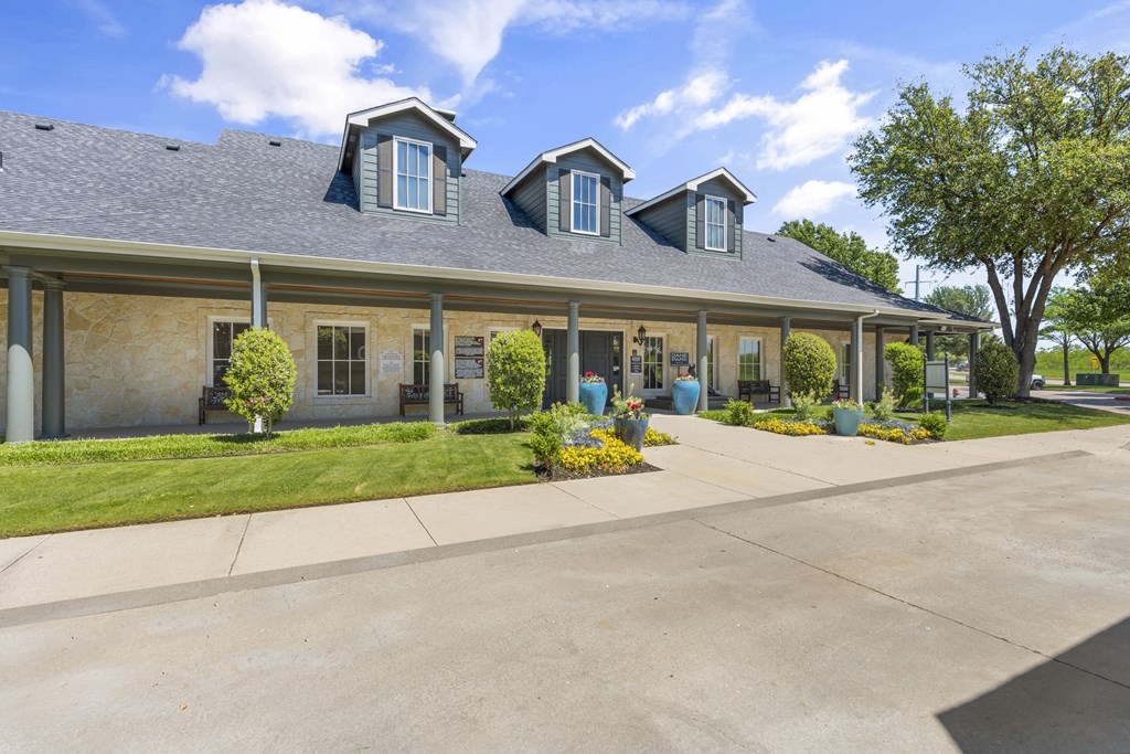 the front of a house with a sidewalk and a driveway