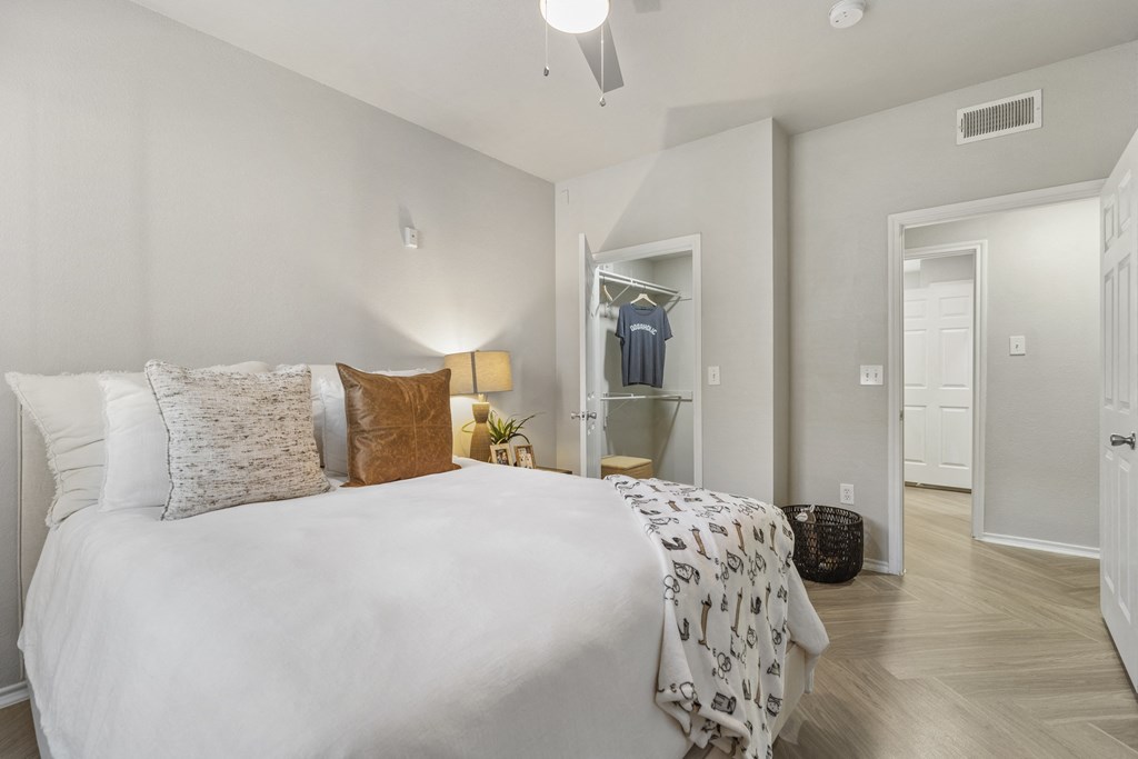 a bedroom with a large bed and a closet