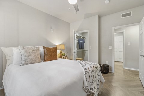 a bedroom with a large bed and a closet