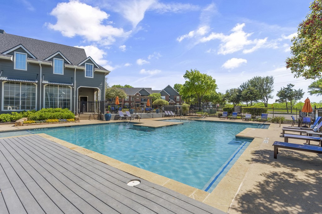 a swimming pool with a house in the background