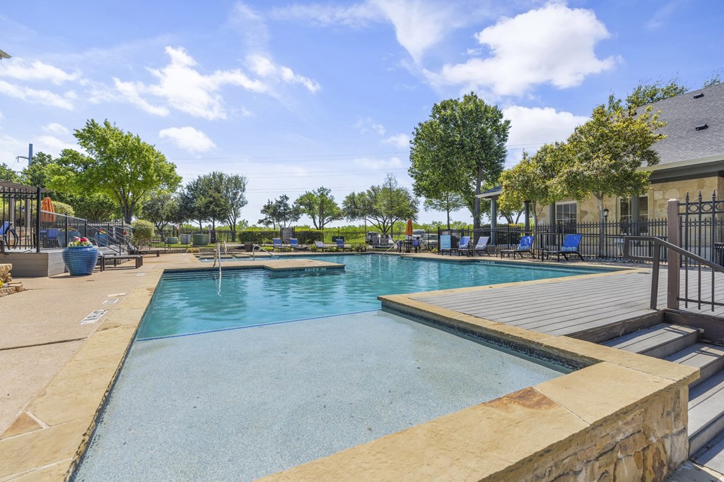 the pool at the preserve at ballantyne commons with trees and a pool house