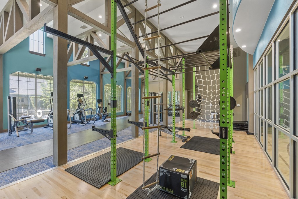 the gym is equipped with a variety of exercise equipment and mirrors