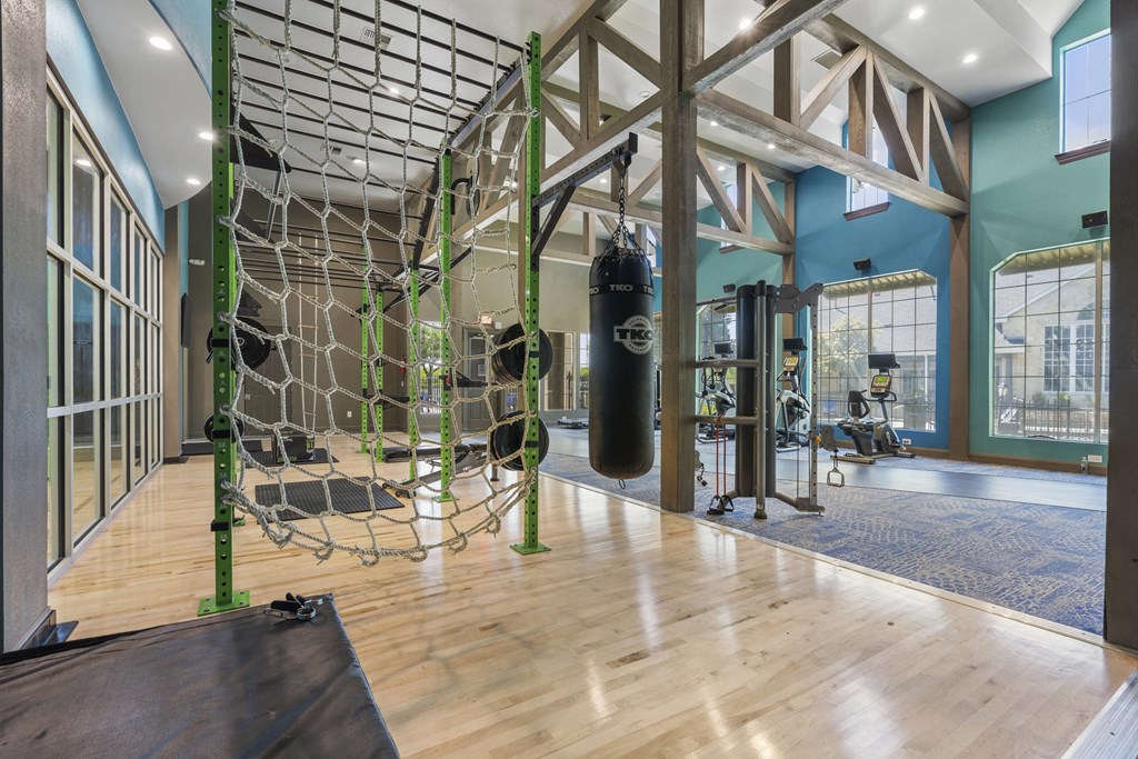 a gym with a soccer net and a punching bag in the middle of it