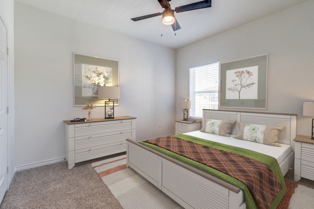 a bedroom with a bed and a ceiling fan