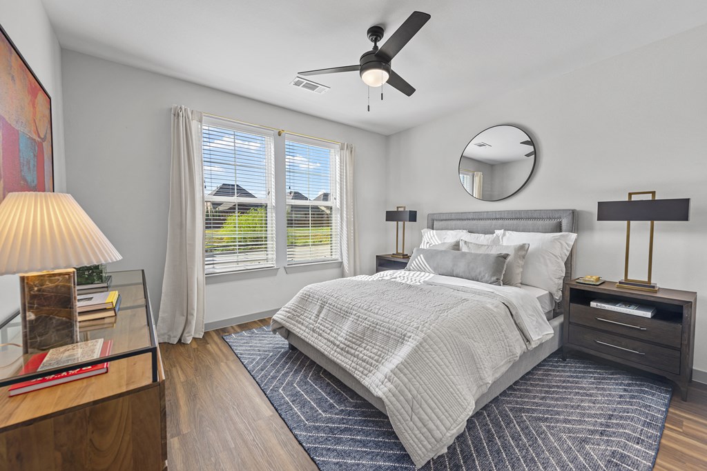a bedroom with a bed and a ceiling fan