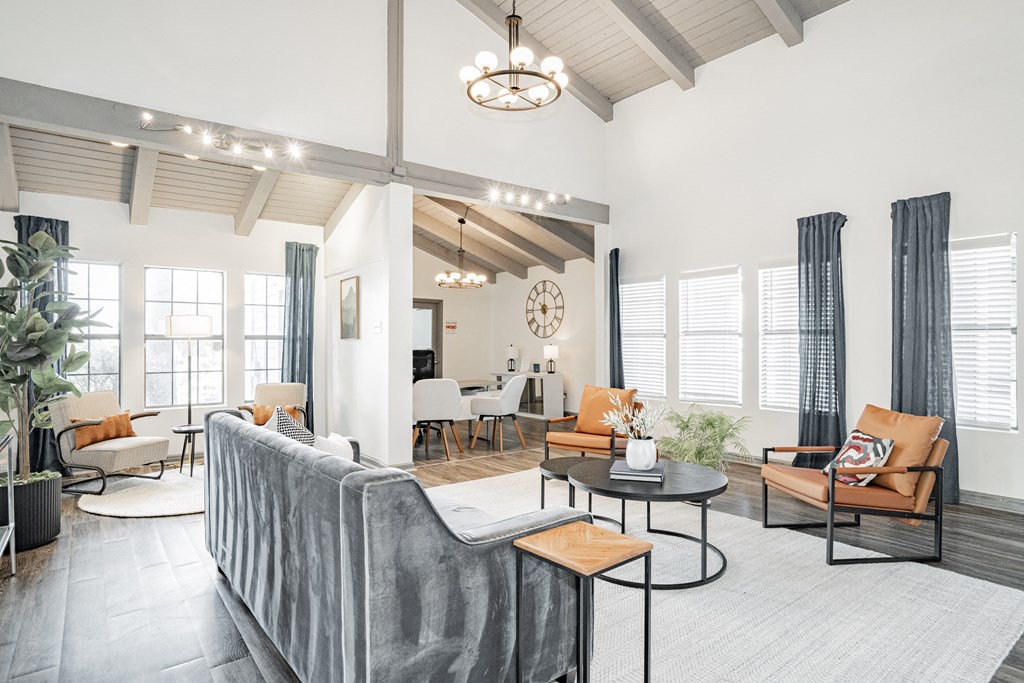 a living room with a couch and chairs and a table