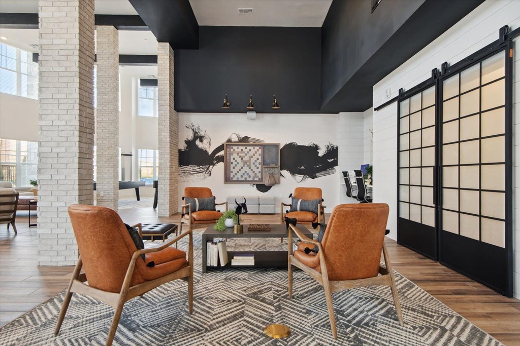 a living room with a couch and chairs and a table