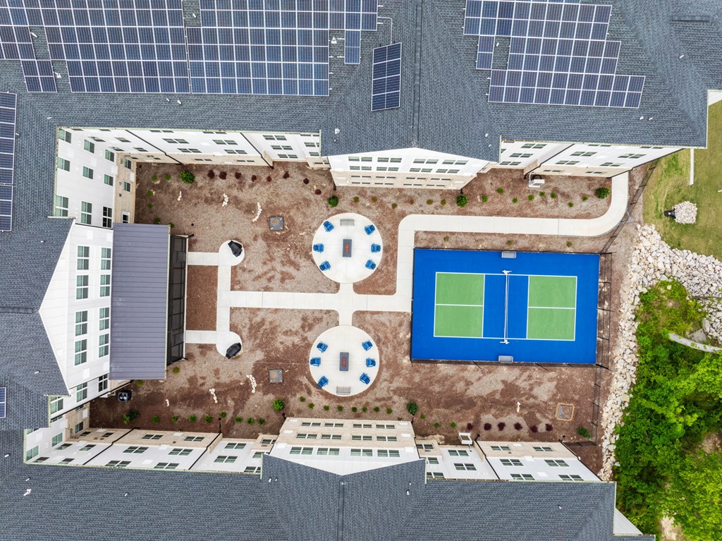 a birds eye view of a tennis court on the roof of a building