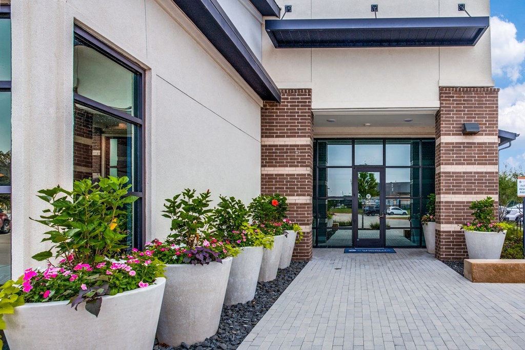 large potted plants in front of the leasing office