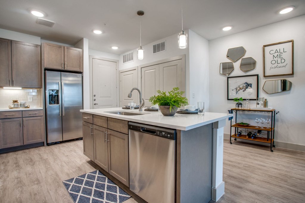 a kitchen with stainless steel appliances and a large counter top