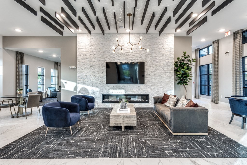 a living room with a couch and chairs and a tv