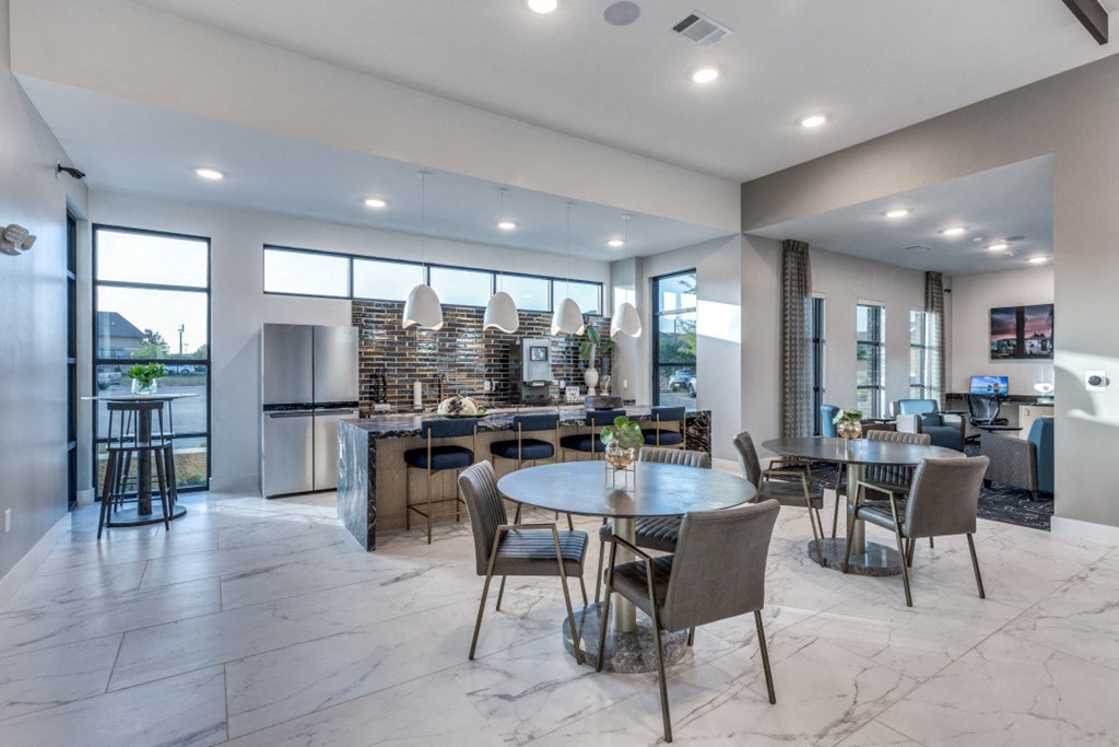 a living room and kitchen with a table and chairs