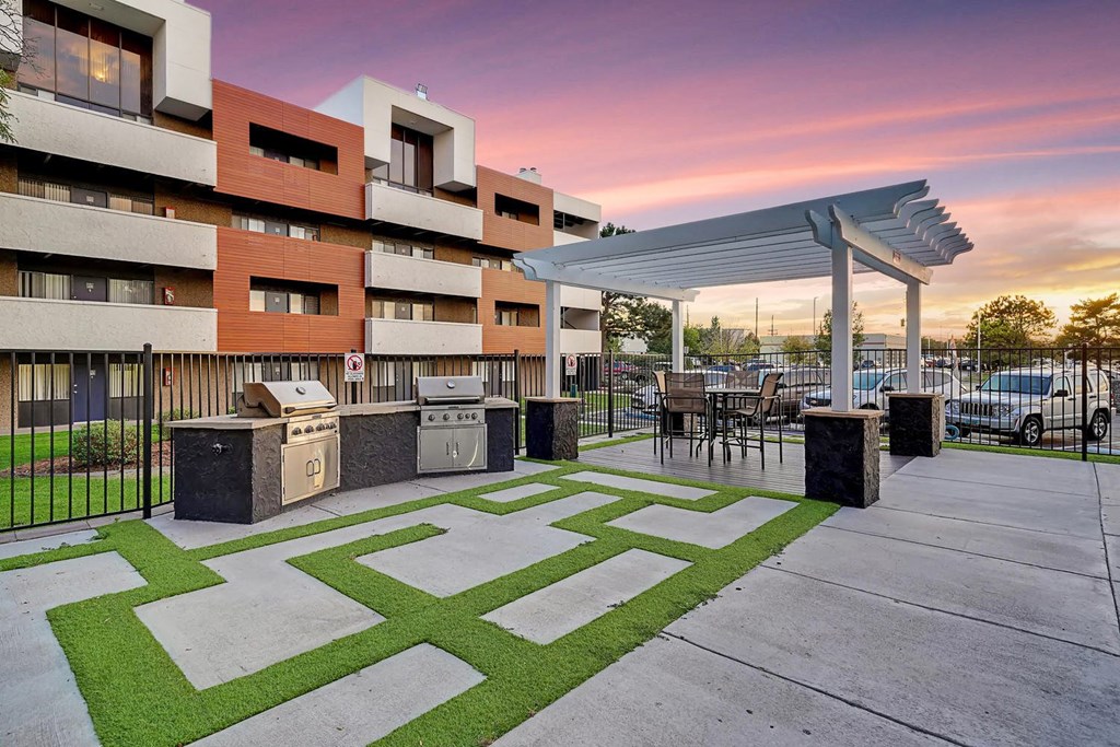 A modern building with a green lawn in front.