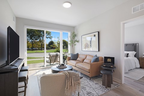 A living room with a brown couch and a television.