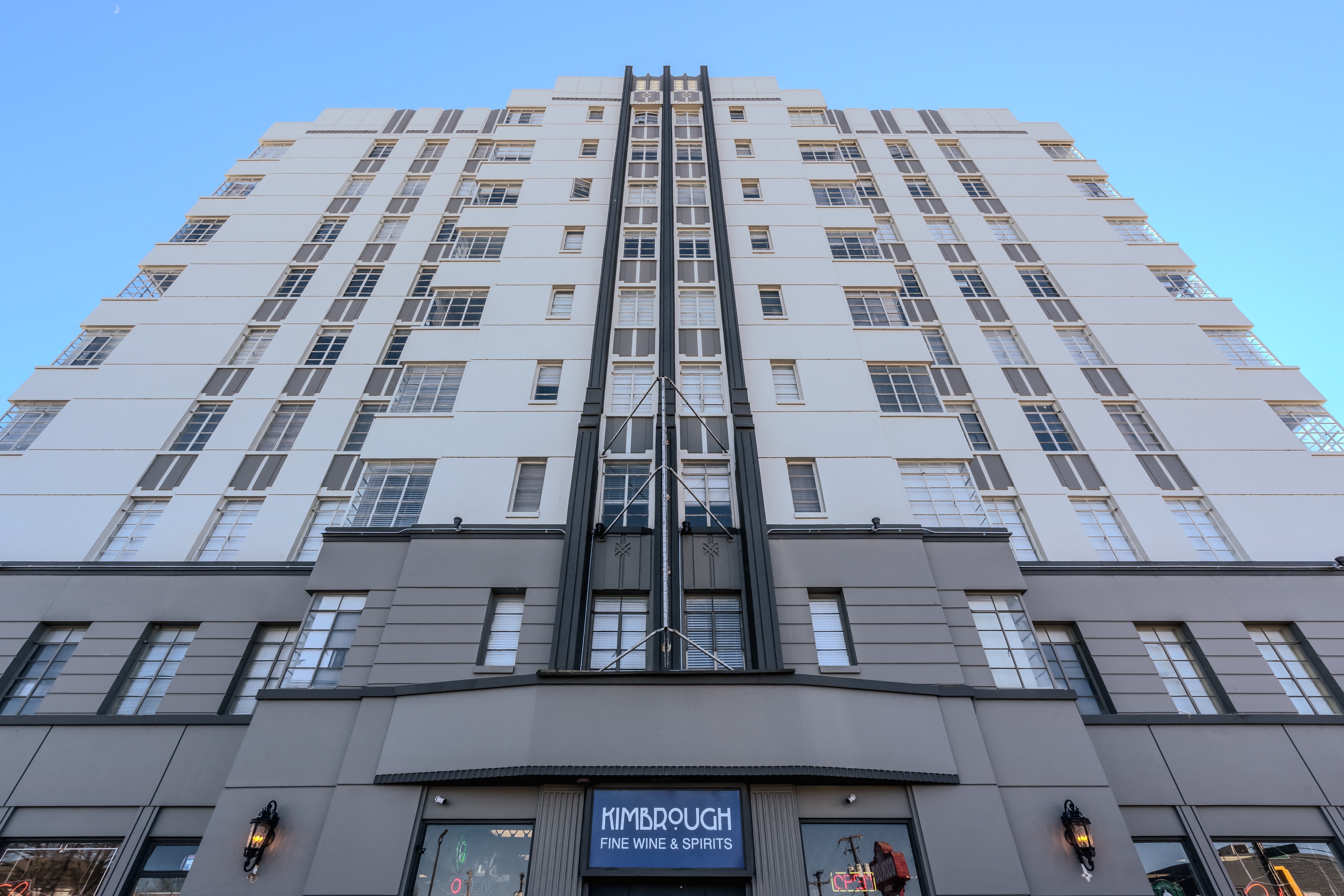 a view of a tall building with a blue sky in the background