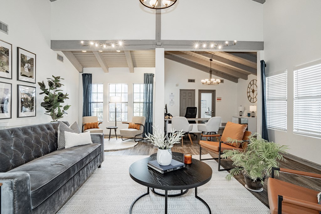 a living room with couches and chairs and a table