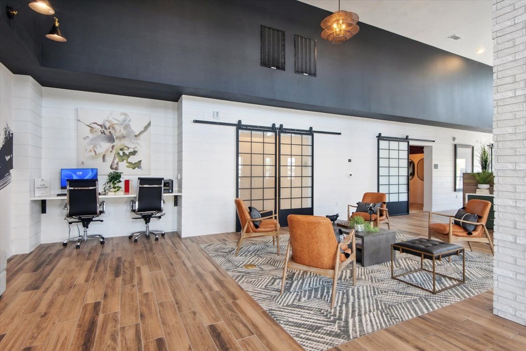 a living room with a couch and chairs and a table
