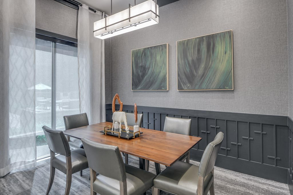 A dining room with a wooden table and grey chairs.
