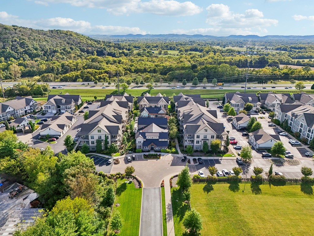 A bird's eye view of a residential area with houses and cars.