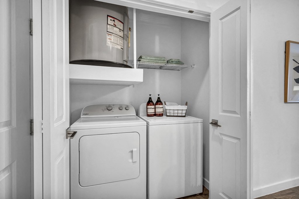 laundry room with a washer and dryer and a cabinet above it
