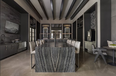 A modern dining room with a large table and chairs.