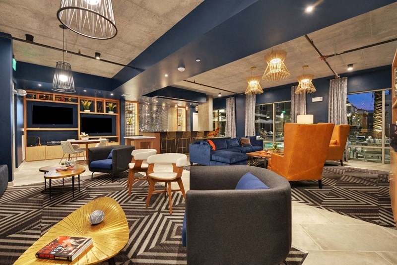 a lobby of a hotel with couches and chairs