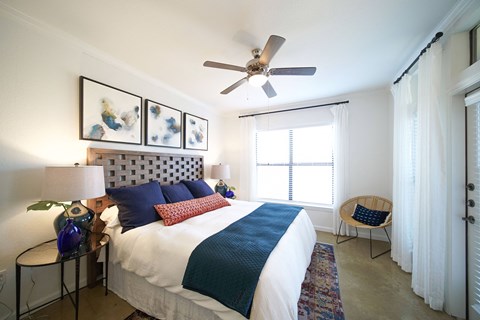 a bedroom with a bed and a ceiling fan