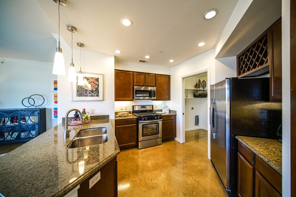 a kitchen with stainless steel appliances and granite counter tops