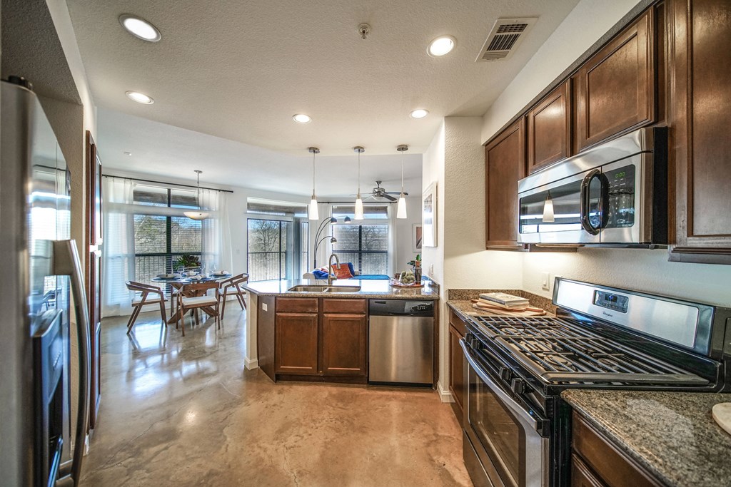 a kitchen with stainless steel appliances and wooden cabinets